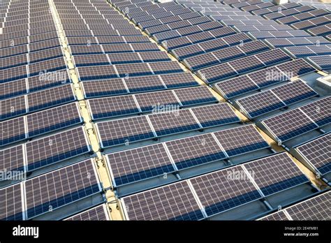 Aerial View Of Many Photo Voltaic Solar Panels Mounted Of Industrial