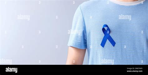 March Colorectal Cancer Awareness Month Woman Holding Dark Blue Ribbon