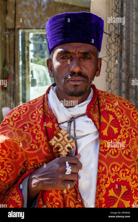 An Ethiopian Orthodox Priest Holding A Cross During The Timkat