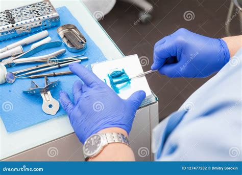 An Orthopedist Dentist Prepares A Polymer Material For Making A Dental