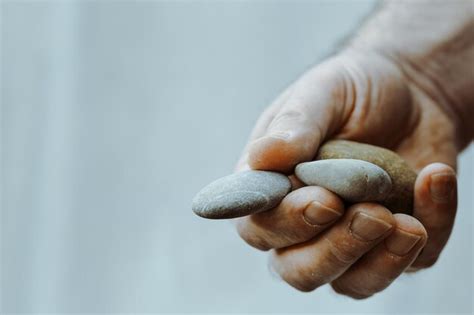 Premium Photo Cropped Hand Of Man Holding Stones