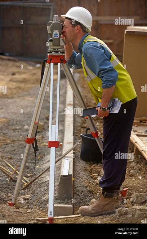 A Construction Worker Uses A Theodolite To Measure Triangulation Angles