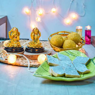 Buy Send Ganesha Laxmi Idols With Sweets And Candles Online Igp