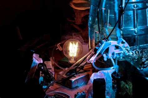 Premium Photo Illuminated Light Bulb On Table In Workshop