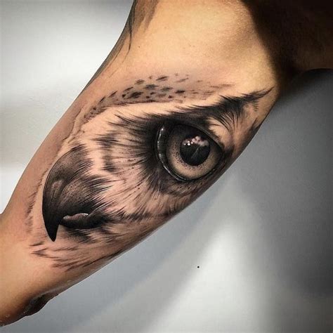 An Owl Eye Tattoo On The Arm