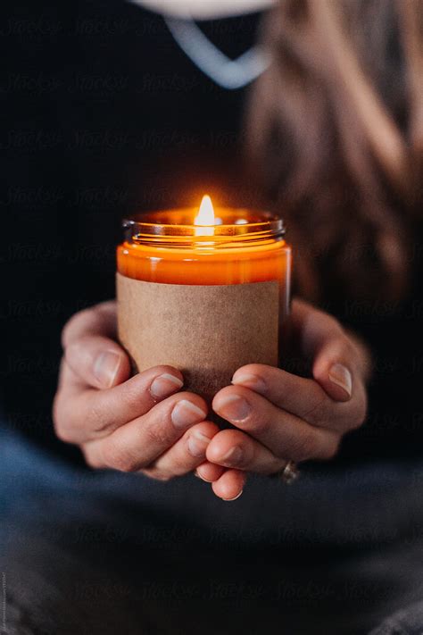 Woman Holding Lit Candle In Hands By Stocksy Contributor Leah Flores