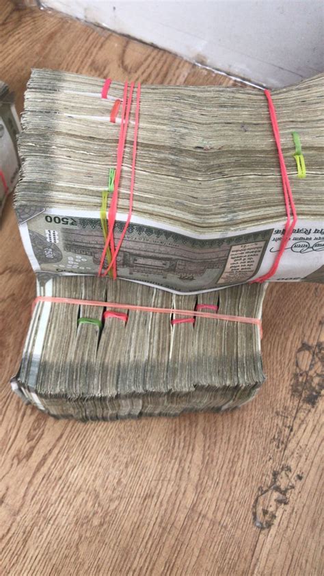 Two Stacks Of Money Wrapped In Red String