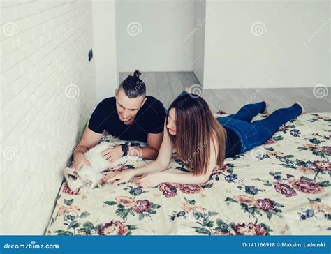 Happy couple and cat stock photo. Image of closeup, girl - 141166918