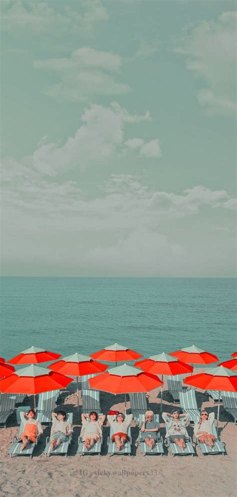 many chairs and umbrellas on the beach near the ocean