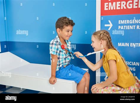 Two Children Playing Doctor In Playroom Stock Photo Alamy