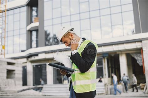 European Engineer In Helmet Looking At Paper Plan Stock Photo Image