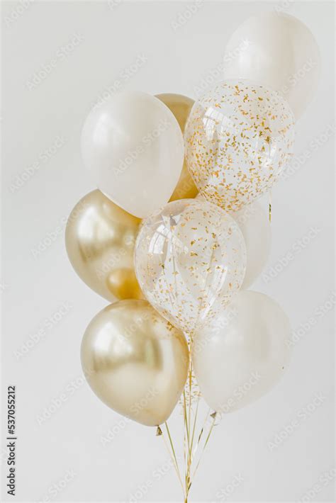 White, gold and transparent glitter balloons. White background. Stock Photo | Adobe Stock