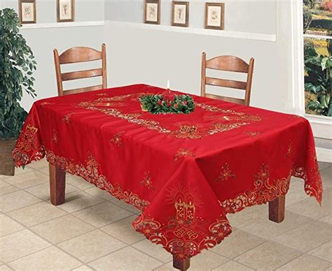 A Red Table Cloth With Gold Designs On It In Front Of A Potted Plant