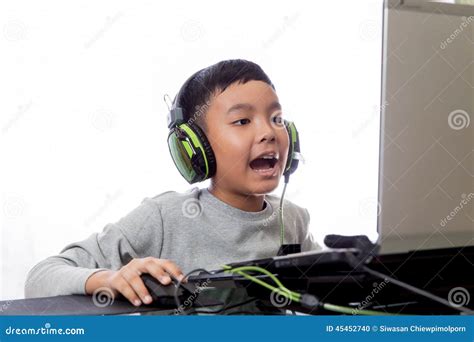 Asian Kid Play Computer Games And Talking With Friend Stock Photo