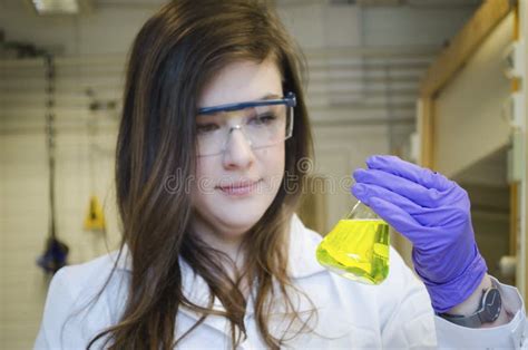 Woman Serious Scientist Holding And Paying Attention Close Up To A