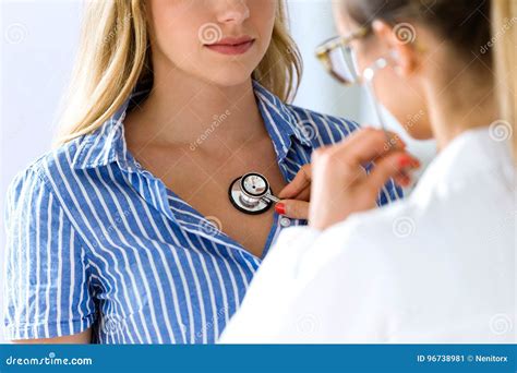 Female Doctor Checking Patient Heartbeat Using Stethoscope Stock Image