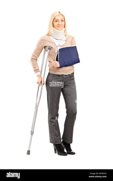 Full Length Portrait Of A Happy Blond Female With Broken Arm Holding A