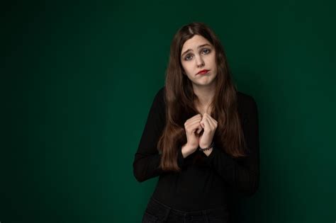 Premium Photo Woman Standing In Front Of Green Wall