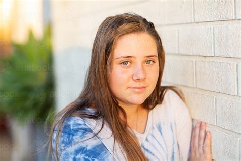 Image Of Teenage Girl With Long Hair Leaning Against A Wall Austockphoto