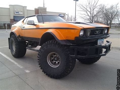 An Orange And Black Truck Parked In A Parking Lot