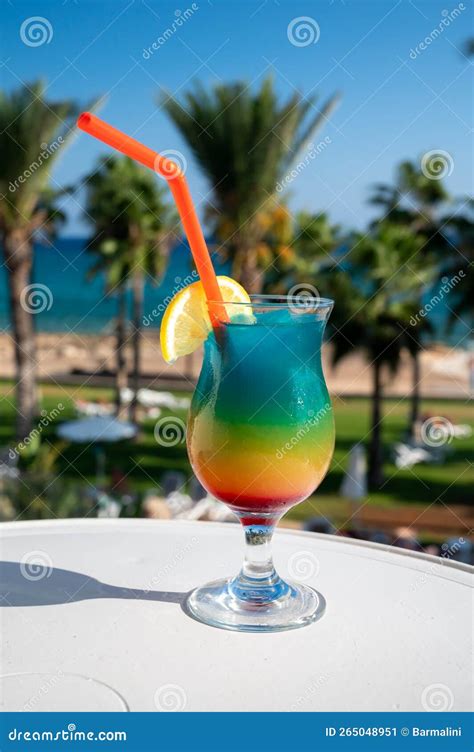 Colourful Cold Rainbow Paradise Cocktail Drink Served In Glass At Pool