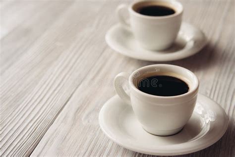 Two Cups Of Coffee On The Table Near The Coffee Machine Stock Photo