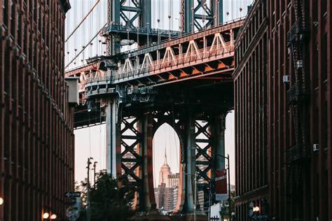 Bridge with metal arch among concrete buildings · Free Stock Photo