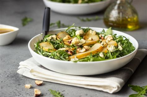 Premium Photo Arugula Gorgonzola Cheese Caramelized Pear And Nut Salad