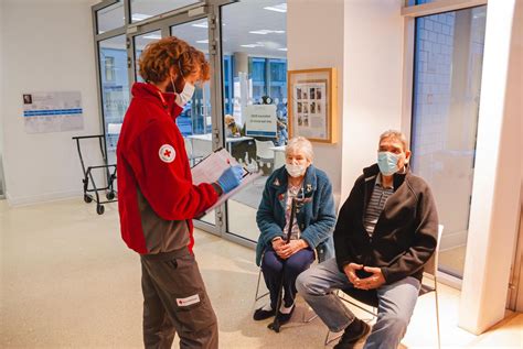 British Red Cross volunteer, Fabian, talking to a couple after they ...