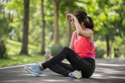 Asian Female Runner Tired After Running In The Park Stock Photo Image