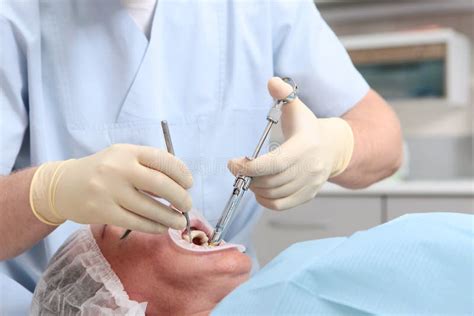 The Dentist Gives An Injection Of Anesthetic Hands In Rubber Gloves