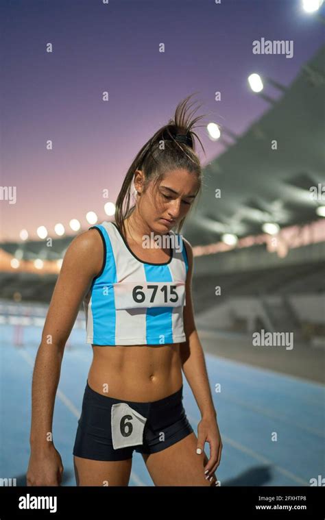 Tired Female Track And Field Athlete On Track After Competition Stock