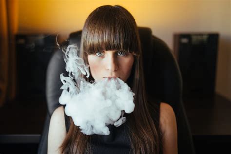 Vaping Young Beautiful Girl Smoking Vaping E Cigarette With Smoke