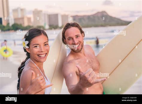 Hawaii Beach Vacation Surfers Couple Doing Shaka Hawaiian Hand Sign