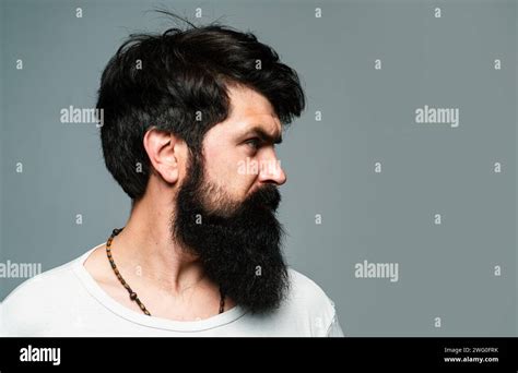 Half Turned Side Profile Portrait Of Serious Man Has Beard And Mustache Looks Seriously