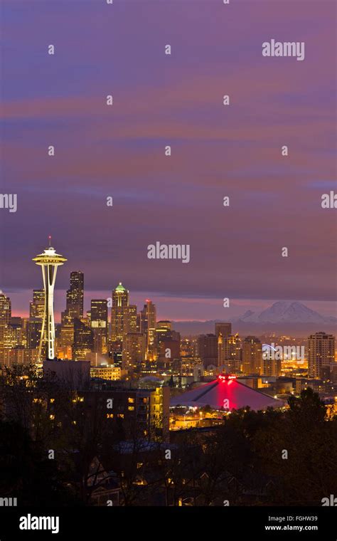 Seattle Skyline during a colorful sunrise, Mount Rainier can be seen in ...