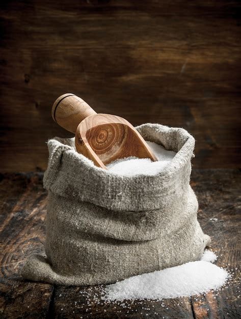 Premium Photo Salt In A Wooden Spoon On Wooden Table