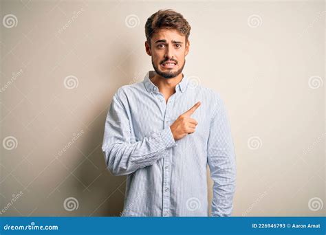 Joven Y Apuesto Hombre Con Barba Y Camisa A Rayas Sobre Fondo Blanco