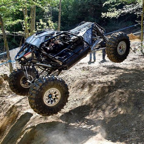 A Man Riding On The Back Of A Four Wheeler Off Road Vehicle In The Woods