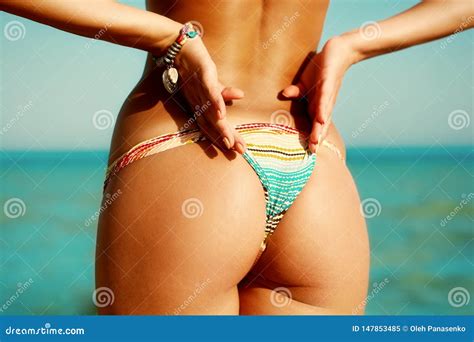 Back Of A Beautiful Woman In Bikini On Sea Background Buttocks Stock