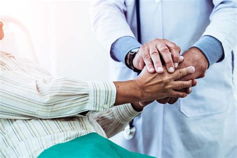 Premium Photo Midsection Of Doctor And Patient Holding Hands