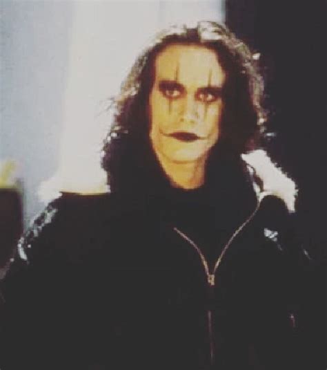 A Man With Long Hair And Makeup Is Wearing A Black Jacket While