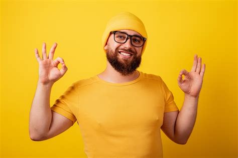 Premium Photo Smiling Bearded Man In Glasses Showing Ok Gesture Over