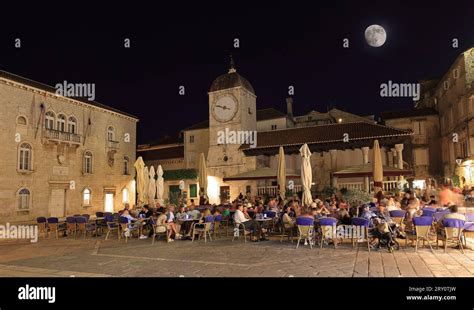 Tourists enjoying restaurants in UNESCO Town of Trogir main square at ...