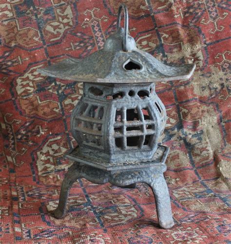 An Old Metal Lantern Sitting On Top Of A Rug