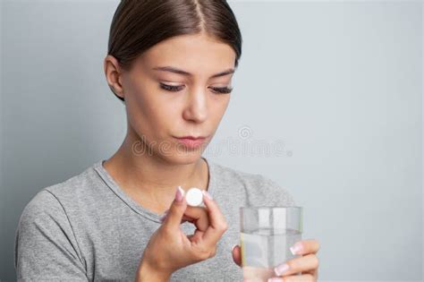 Woman Holding Pill And Glass Water Taking Medicine From Headache