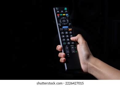 Woman Hand Holding Tv Remote Control Stock Photo 2226427015 Shutterstock