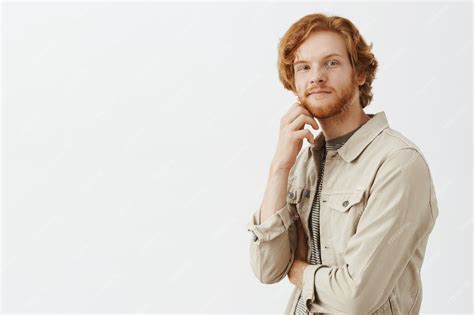 Free Photo Thoughtful And Intrigued Bearded Redhead Guy Posing