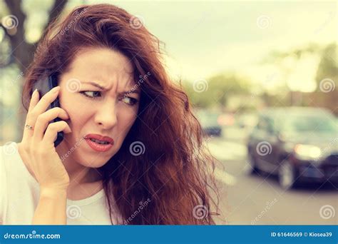 Unhappy Angry Young Woman Talking On Mobile Phone Looking Frustrated