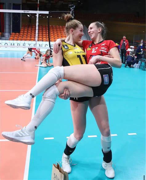 Two Female Volleyball Players Hugging Each Other On The Court